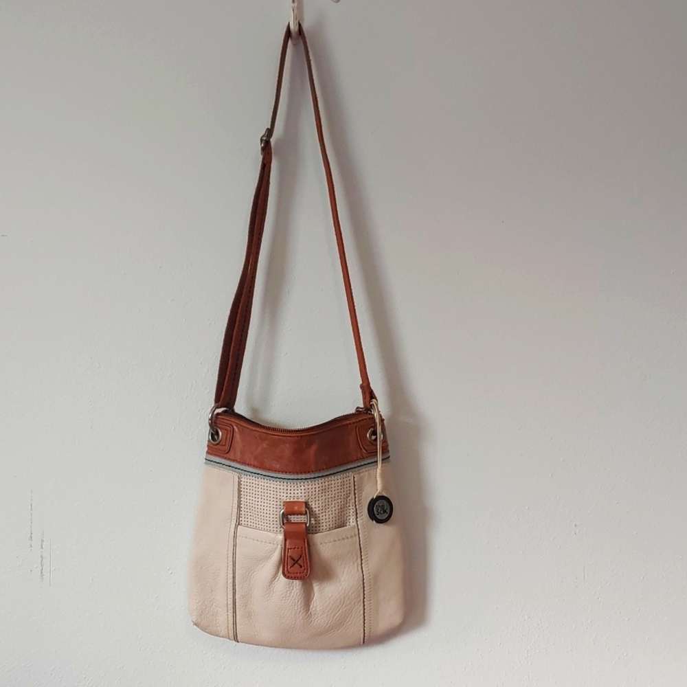 The Sak crossbody purse cream and brown leather multiple pocket.